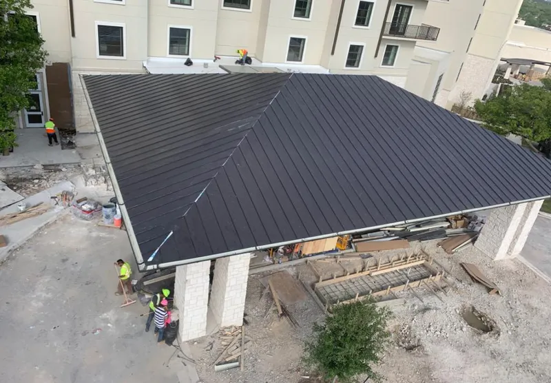 Metal roofing installation team working on a commercial building in Wailua Homesteads